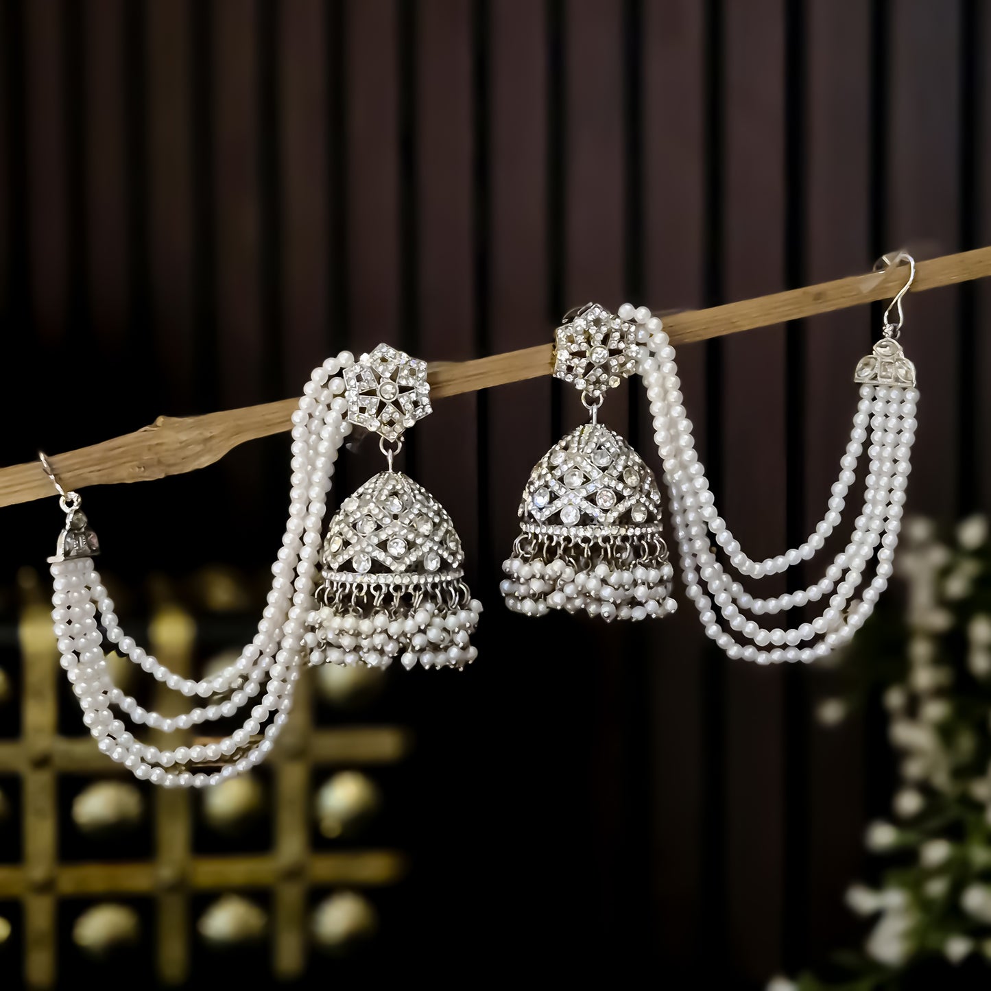 Rihana Rhodium Reverse AD Jhumka Earrings with Earchain - Silver