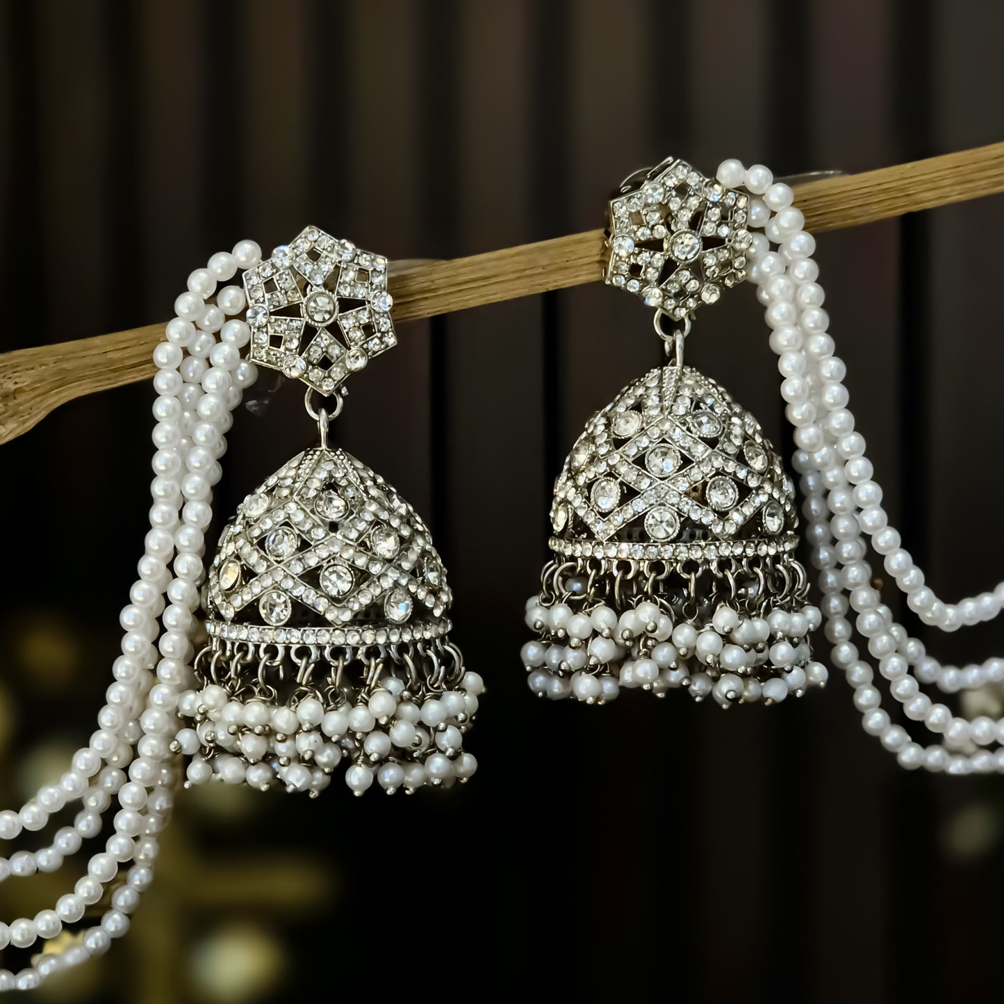 Rihana Rhodium Reverse AD Jhumka Earrings with Earchain - Silver