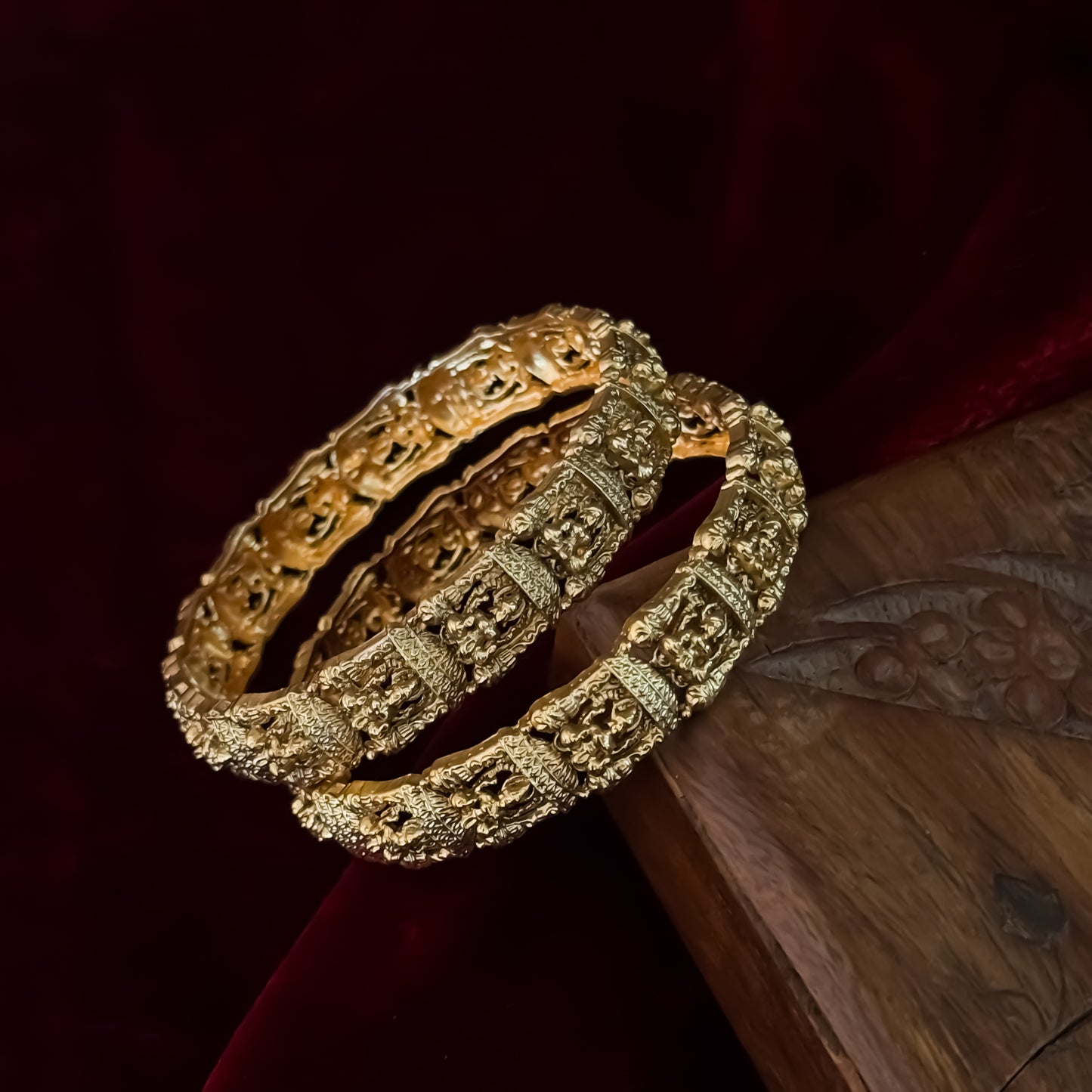 Tarakshi premium antique gold temple bangles featuring continuous rows of sculpted goddess lakshmi motifs in micro arches