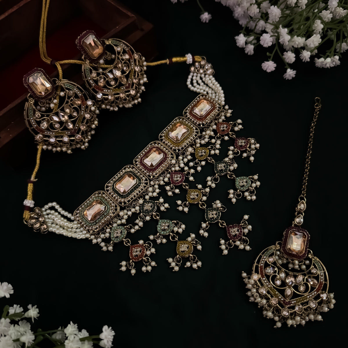 Traditional antique gold bridal jewelry set featuring a multicolored enameled statement choker champagne rectangle gemstones and cascading seed pearl drops