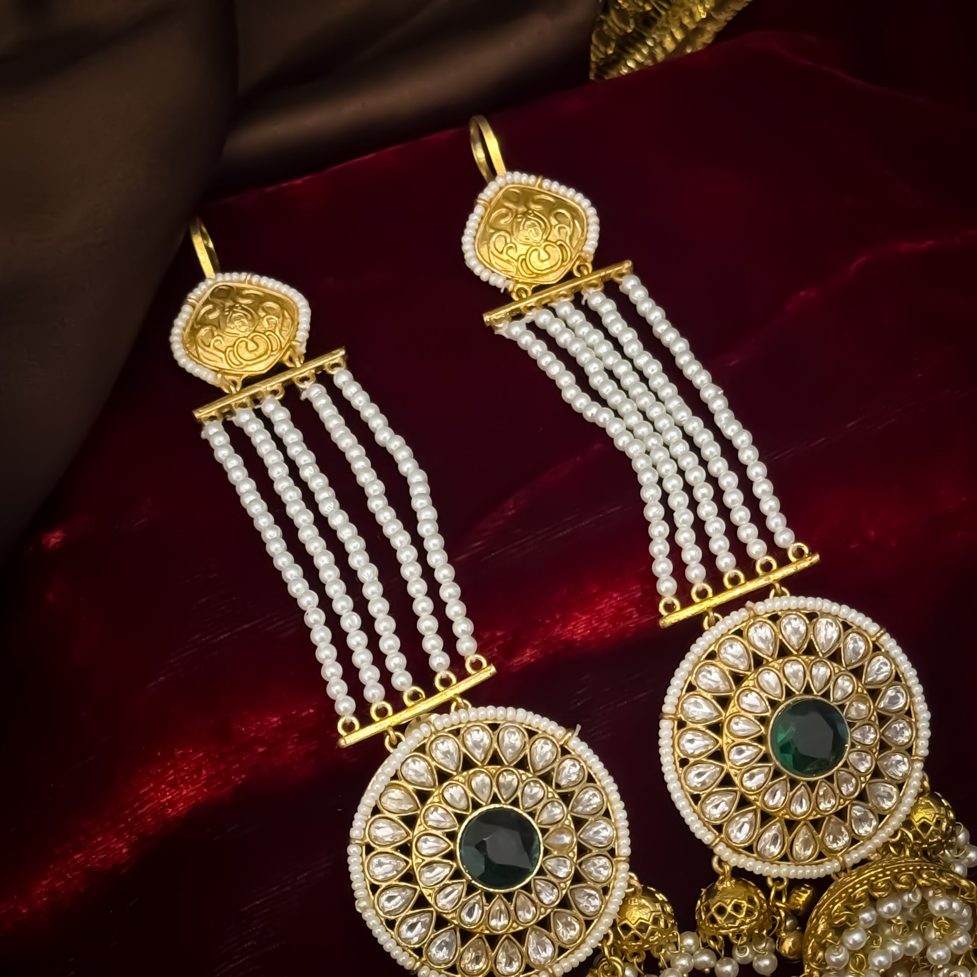 Raanisa premium antique gold kashmiri jhumka earrings featuring five strand pearl ear chains large circular kundan wheel medallion with green center stone and cluster pearl drops