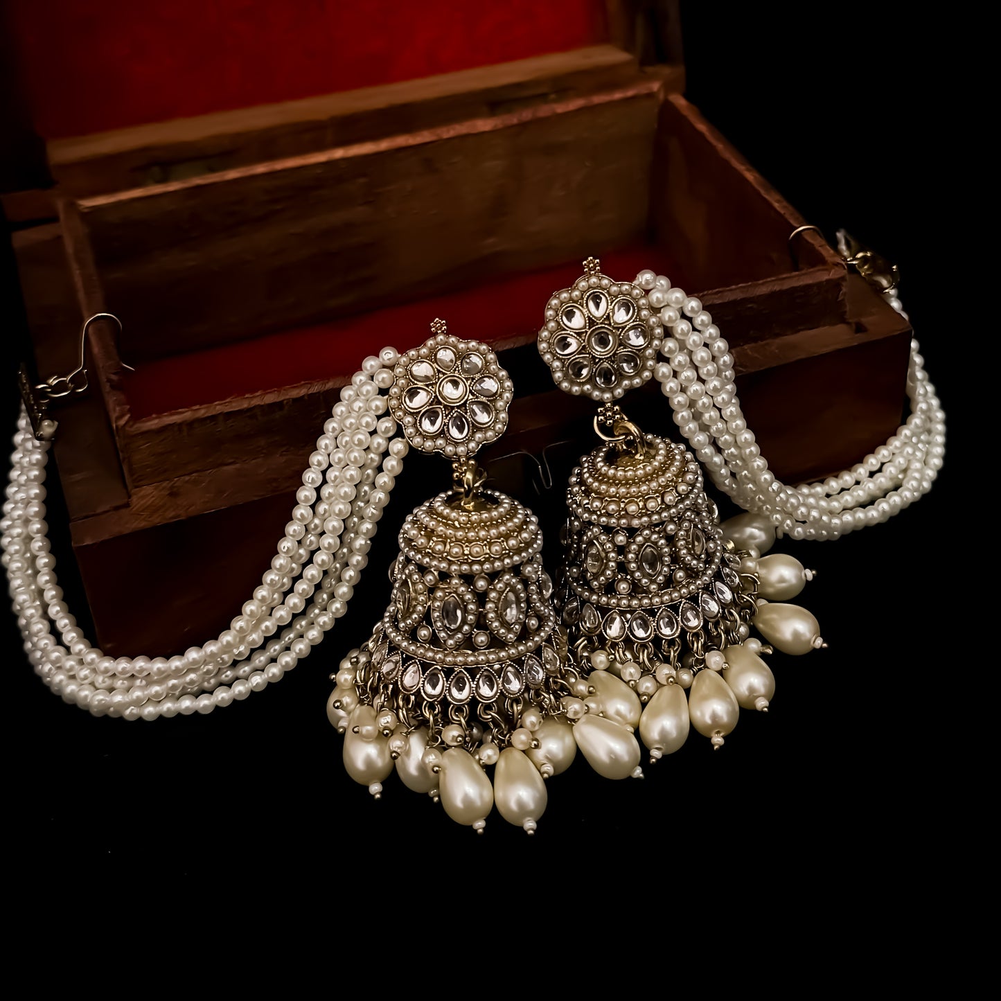 Traditional antique gold reverse american diamond bridal earrings featuring monochromatic white pearls with cascading teardrop drops and pearl sahara support chains