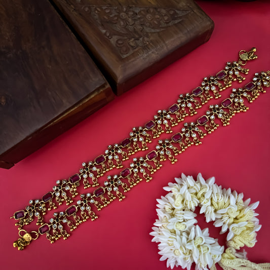 Floral Temple premium antique gold anklet pair featuring flexible double strand woven chain bands linked circular ruby pink and green kemp stone rosettes and cascading gold ghungroo fringes