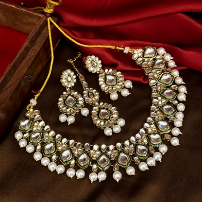 Kumud premium antique gold kundan choker necklace set featuring emerald green enamel borders and hanging white pearl drops with matching earrings and maang teeka