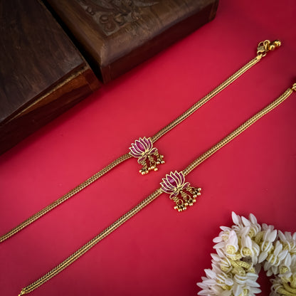 Lotus Bairagi premium antique gold temple anklet pair featuring flexible double strand woven rope chains a hand painted pink meenakari lotus flower centerpiece and dangling gold ghungroo bell clusters