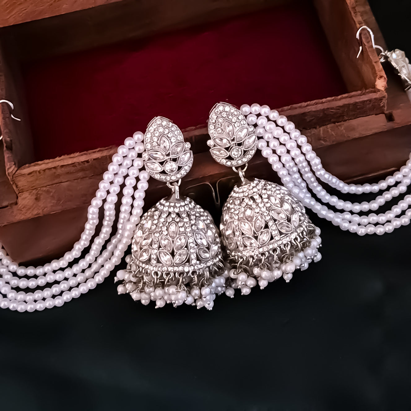 Kareena Rhodium Reverse AD Jhumka Earrings with Earchain - Silver