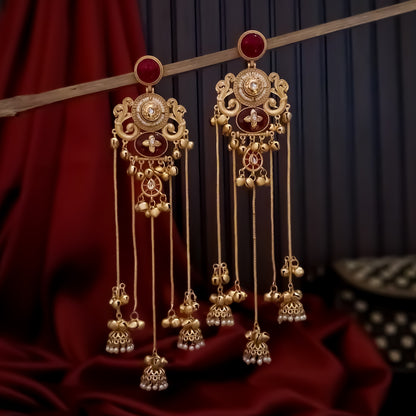 haya premium matte gold kashmiri earrings featuring round ruby studs openwork peacock filigree shields quatrefoil maroon enamel medallions and five long dangling gold chains ending in micro pearl jhumkas