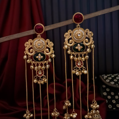 Chaya premium matte gold kashmiri earrings featuring round ruby studs openwork peacock filigree shields quatrefoil maroon enamel medallions and five long dangling gold chains ending in micro pearl jhumkas