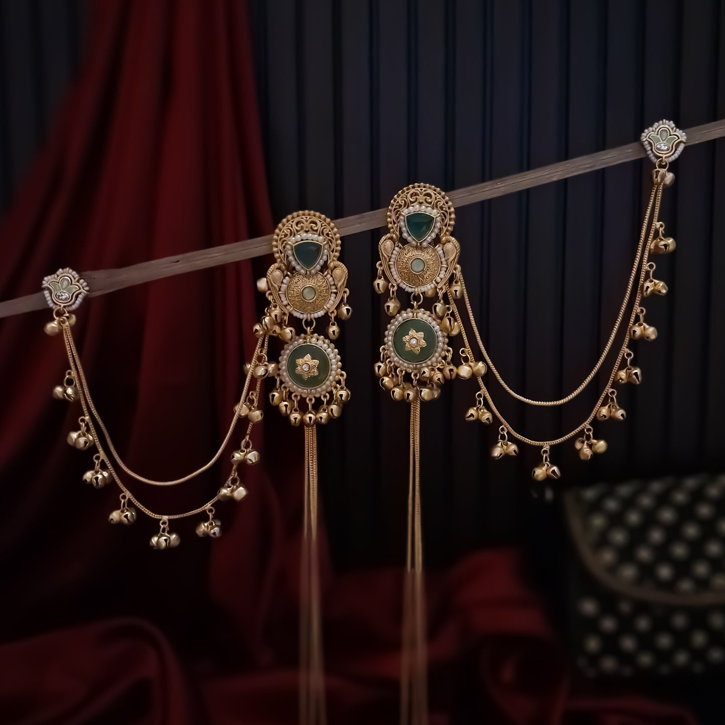 Yukti premium matte gold kashmiri earrings featuring ruby meenakari teardrop studs dual circular medallions white pearl frames long vertical ghungroo tassel chains and a detachable double strand bell sahara hair chain