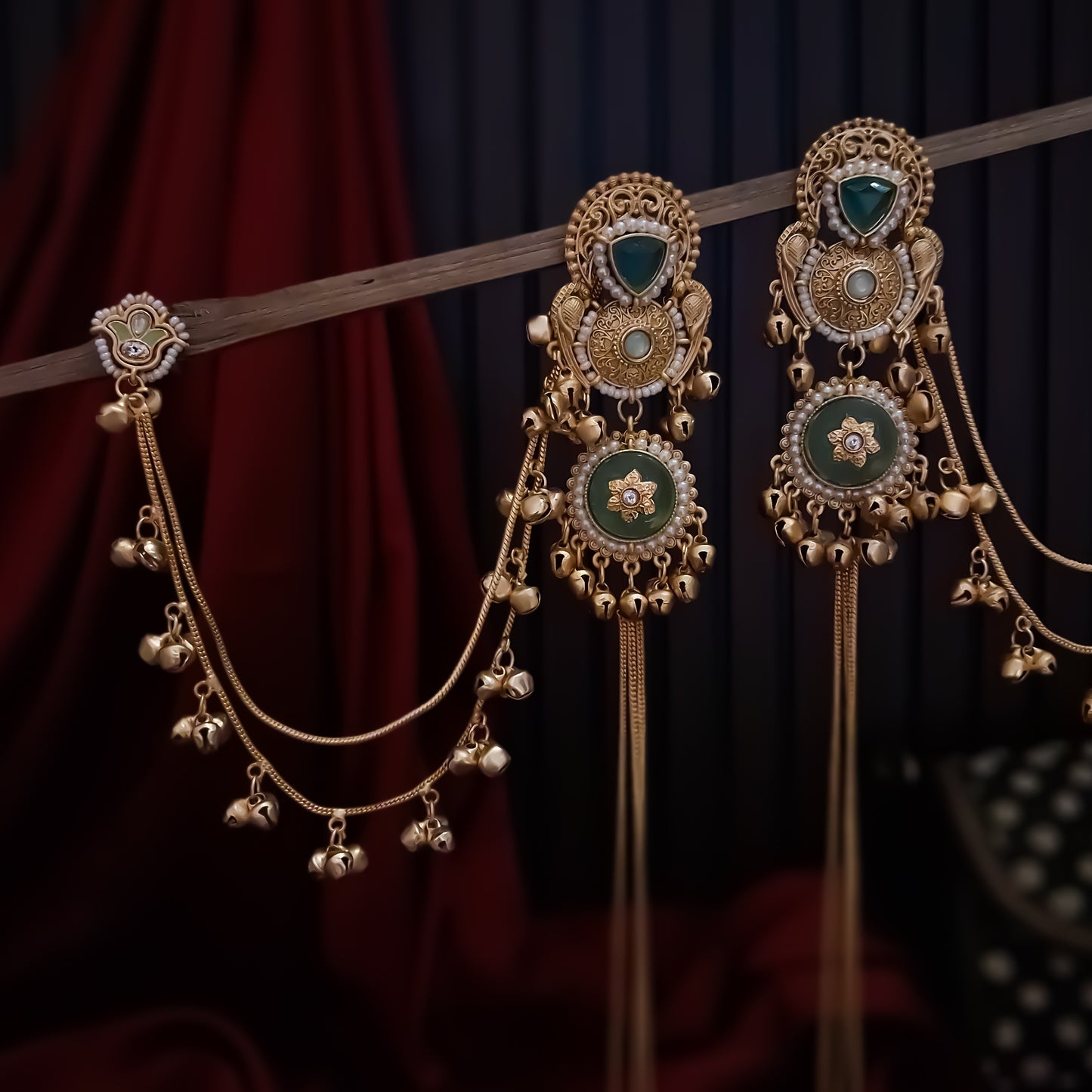 Yukti premium matte gold kashmiri earrings featuring ruby meenakari teardrop studs dual circular medallions white pearl frames long vertical ghungroo tassel chains and a detachable double strand bell sahara hair chain
