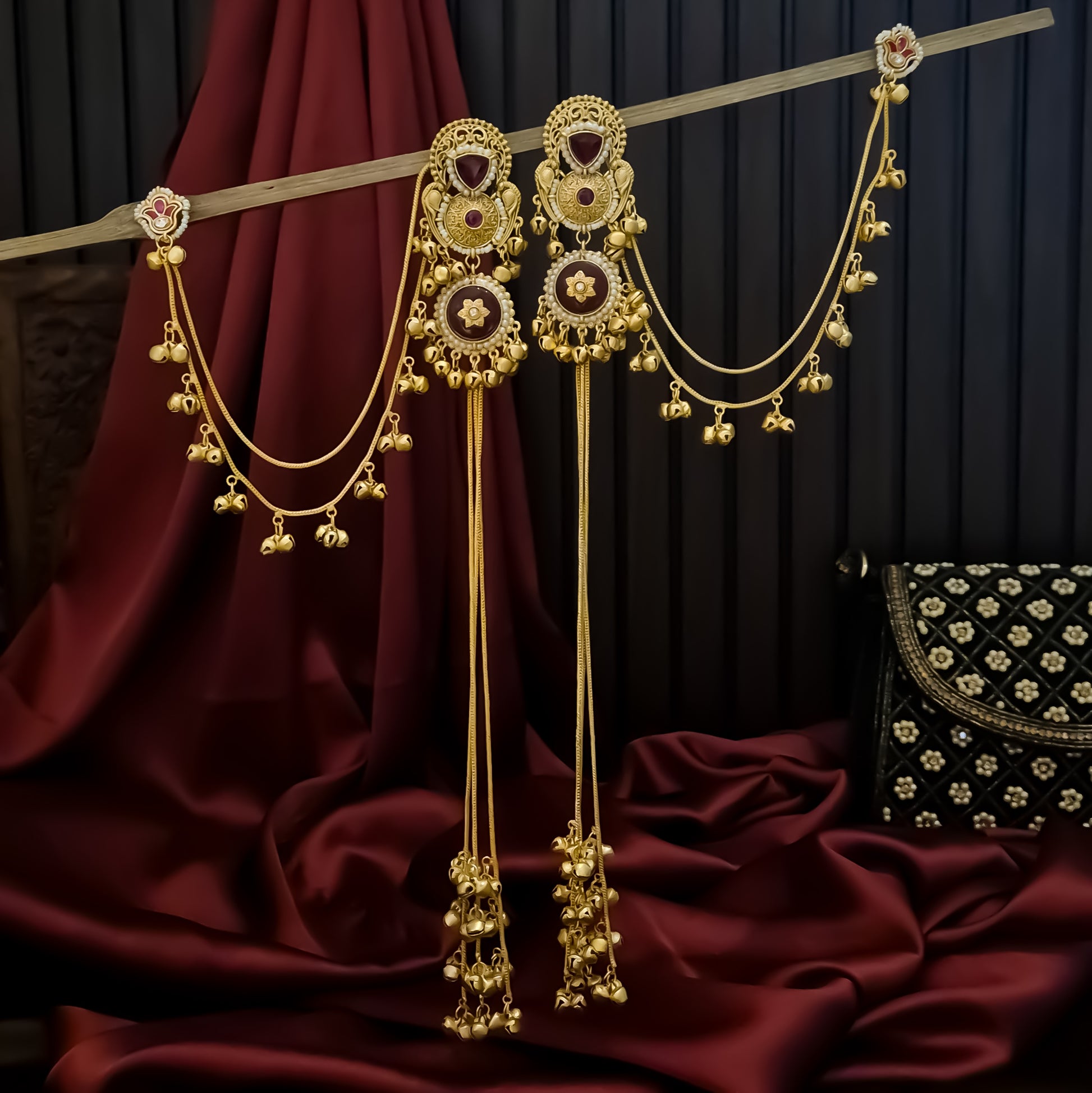 Yukti premium matte gold kashmiri earrings featuring ruby meenakari teardrop studs dual circular medallions white pearl frames long vertical ghungroo tassel chains and a detachable double strand bell sahara hair chain