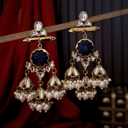 Sayani premium antique gold kundan chandelier earrings featuring a geometric top post a horizontal bar a central royal blue carved stone flower rosette and multiple mini dome jhumkas with dense pearl fringes