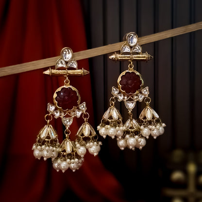 Sayani premium antique gold chandelier earrings featuring a carved round red stone floral medallion triple hanging jhumka domes with leaf crystals and ivory pearls