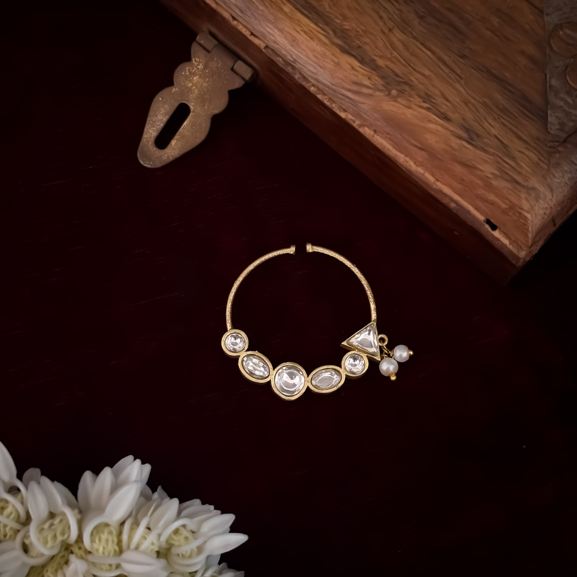 Shreya premium antique gold kundan nose clip nath featuring a non pierced hoop encrusted with a crescent arch of multi shape clear dabi stones a triangular tip and two swinging white pearls