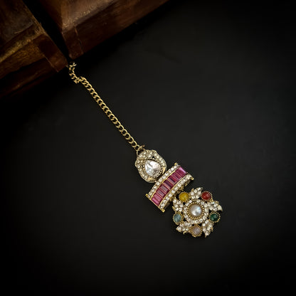 Ashwini Sabyasachi style premium antique gold kundan multi color necklace set featuring a segmented panel collar tracking of multi shape multicolored gemstone baguettes sunburst kundan rosettes white pearls matching tiered earrings and maang tikka