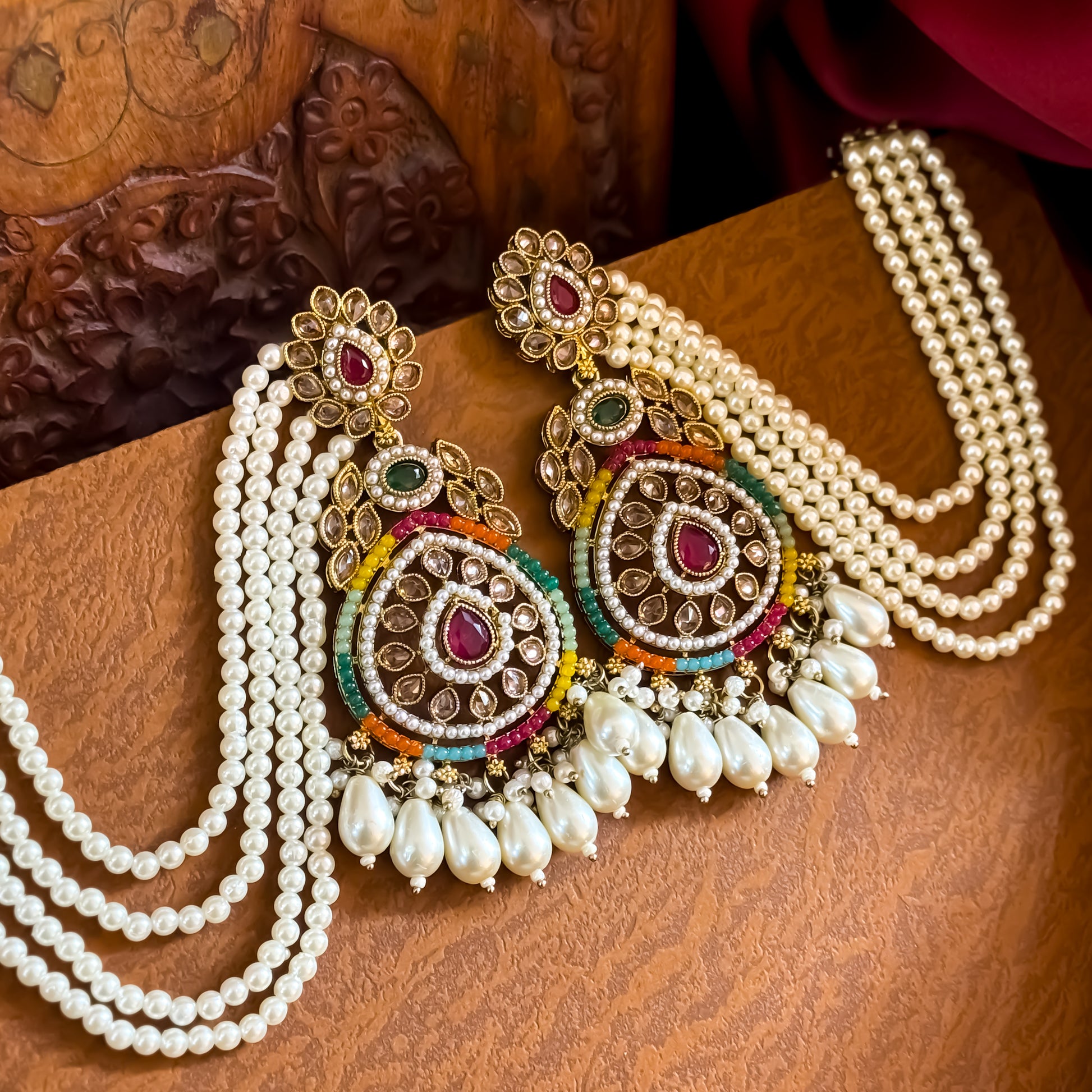 Kanika premium antique gold reverse AD chandbali earrings featuring five layered pearl sahara chains and a matching multicolor maang teeka set flat lay