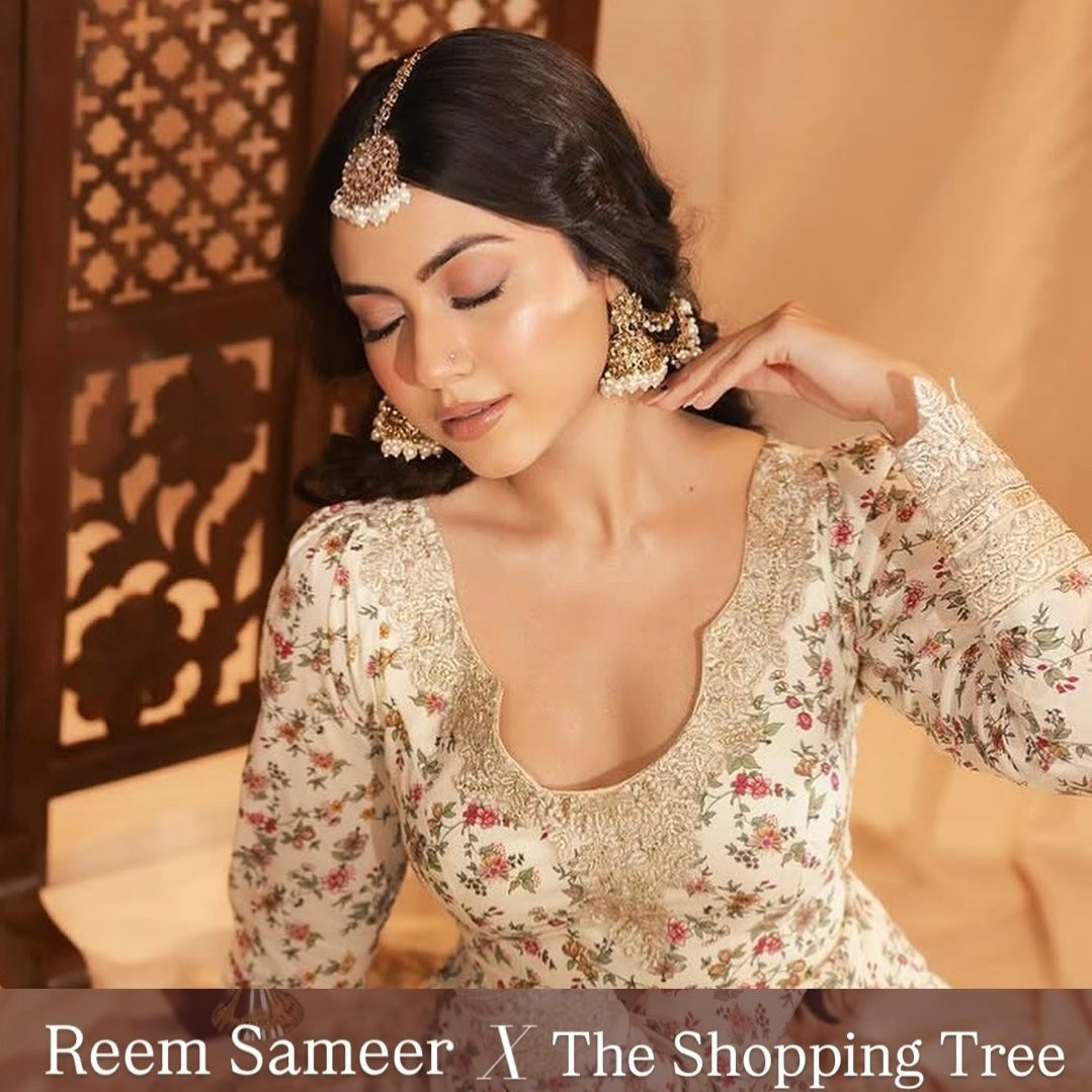 Traditional antique gold kundan mirror work bridal jewelry set styled on a woman with loose dark hair wearing a cream floral embroidered lehenga blouse