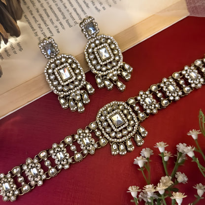 Ruhanika premium antique gold kundan broad choker necklace set featuring a segmented panel collar tracking of rectangular pastel pink quartz stones a large central rounded rectangular medallion matching tiered dropdown earrings