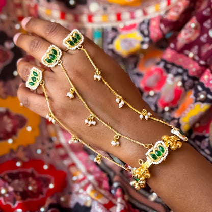 Kamaltika adjustable brass three finger haathphool pair featuring emerald green enameled lotus charms with small hanging seed pearls