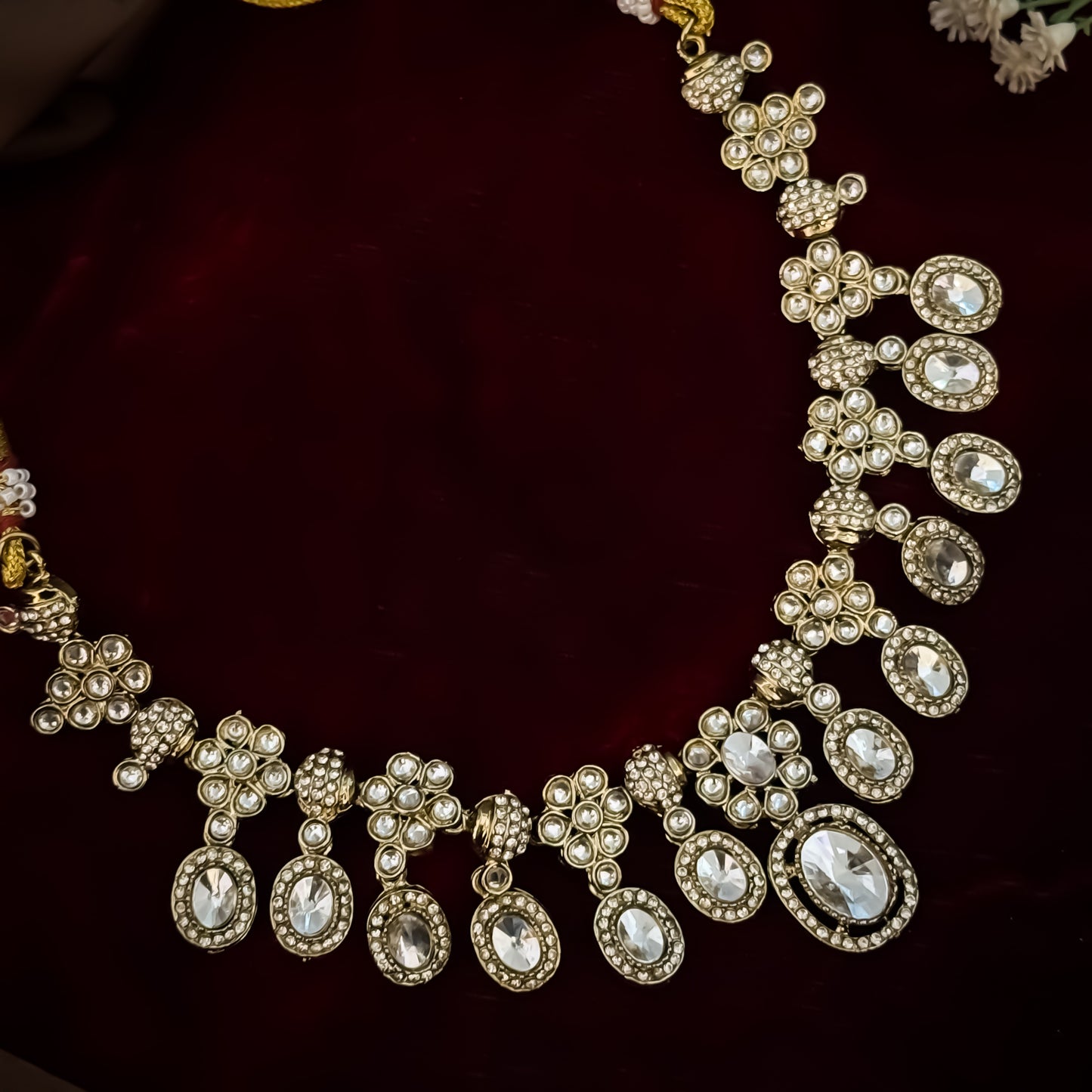 Golden Tayani premium zircon kundan necklace set featuring floral clusters scalloped oval stones with micro crystal halos and large teardrop center drop matching earrings
