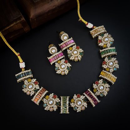 Ashwini Sabyasachi style premium antique gold kundan multi color necklace set featuring a segmented panel collar tracking of multi shape multicolored gemstone baguettes sunburst kundan rosettes white pearls matching tiered earrings and maang tikka