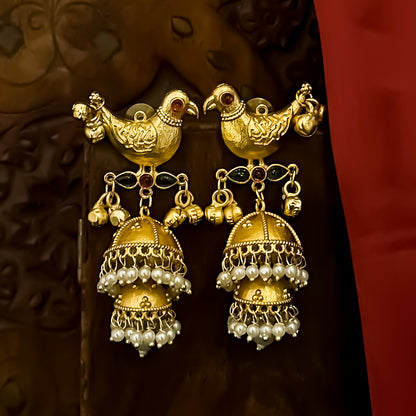 Totapari premium kashmiri brass jhumka earrings featuring sculpted gold peacock studs red and green stone links and three tiered pearl domes