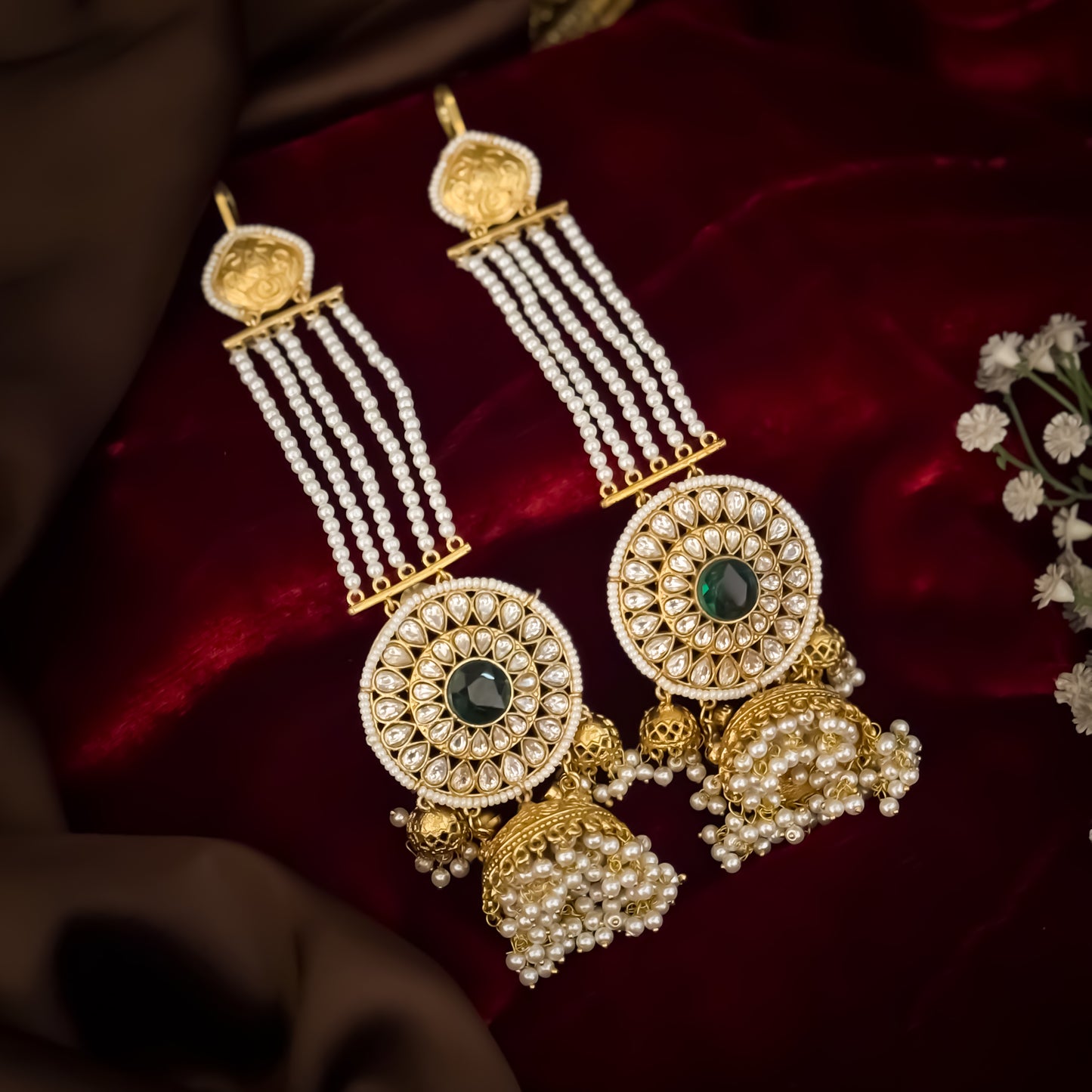 Raanisa premium antique gold kashmiri jhumka earrings featuring five strand pearl ear chains large circular kundan wheel medallion with green center stone and cluster pearl drops