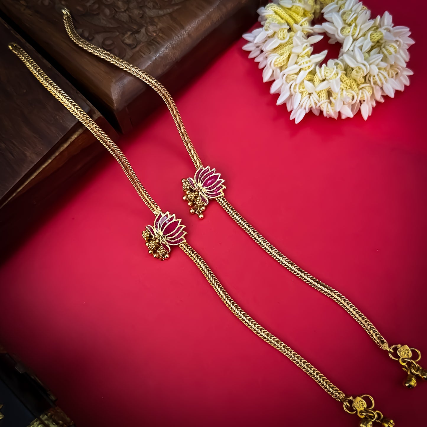 Lotus Bairagi premium antique gold temple anklet pair featuring flexible double strand woven rope chains a hand painted pink meenakari lotus flower centerpiece and dangling gold ghungroo bell clusters