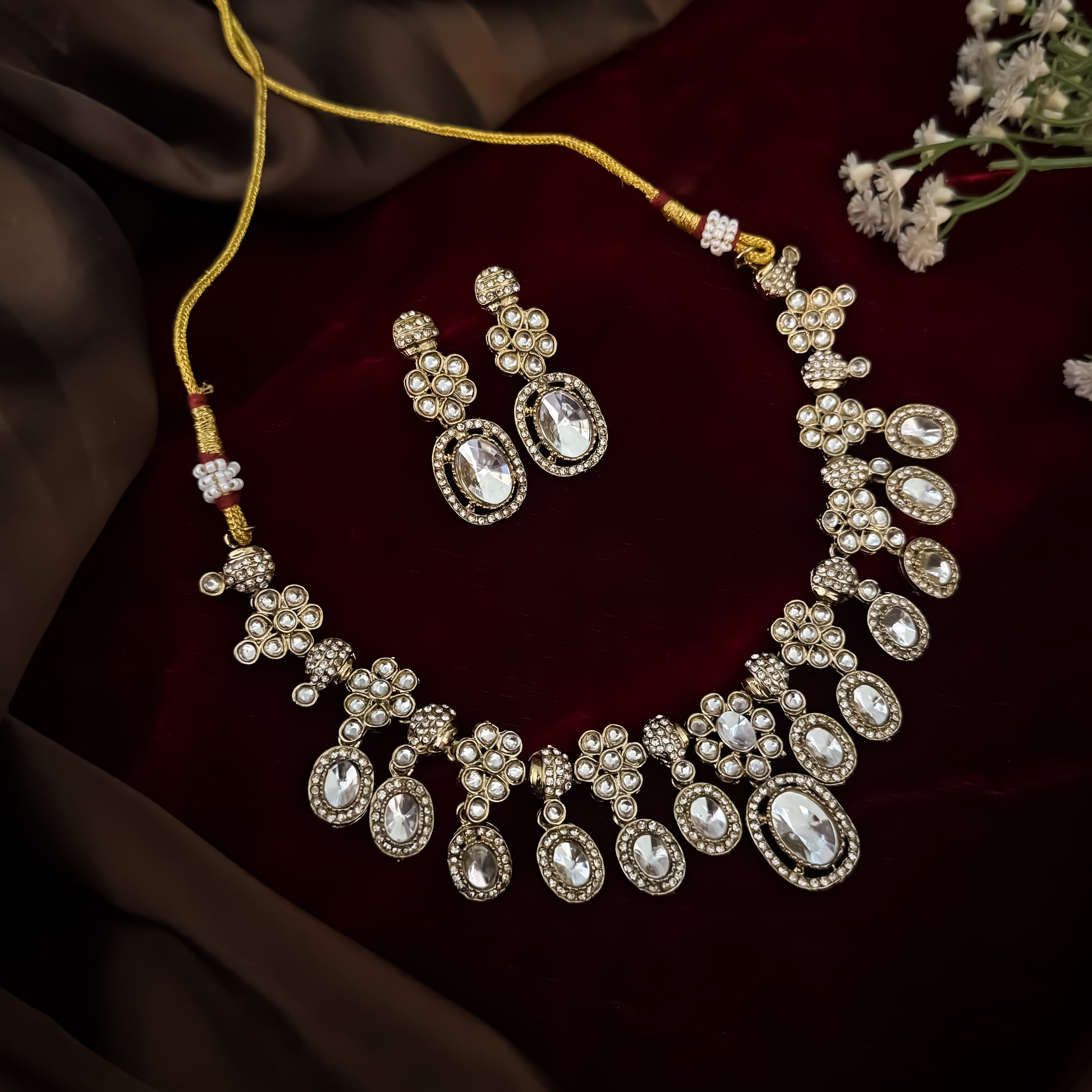 Golden Tayani premium zircon kundan necklace set featuring floral clusters scalloped oval stones with micro crystal halos and large teardrop center drop matching earrings