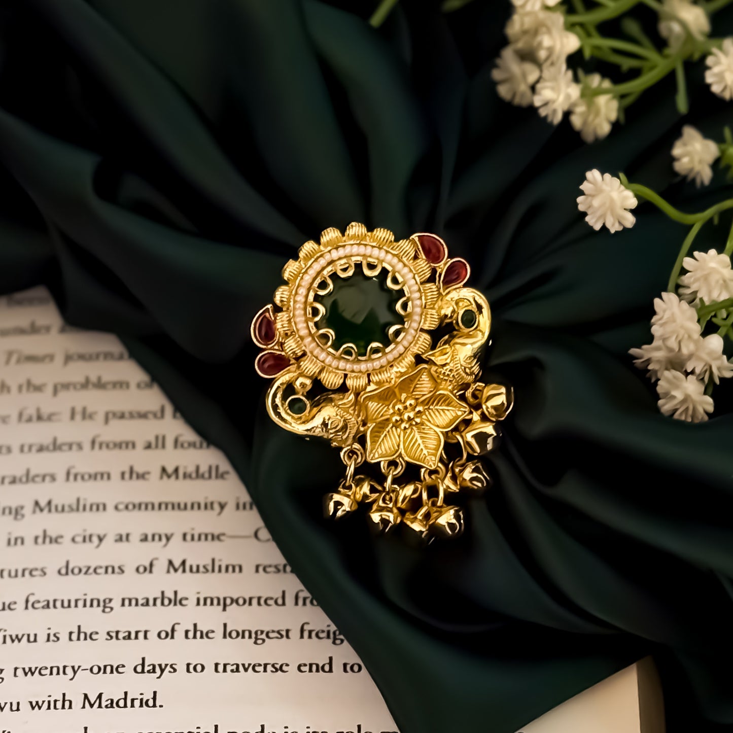 Nishita premium antique brass kashmiri ring featuring a large circular emerald green stone surrounded by a dense fringe of mini dangling ghunghroo bells