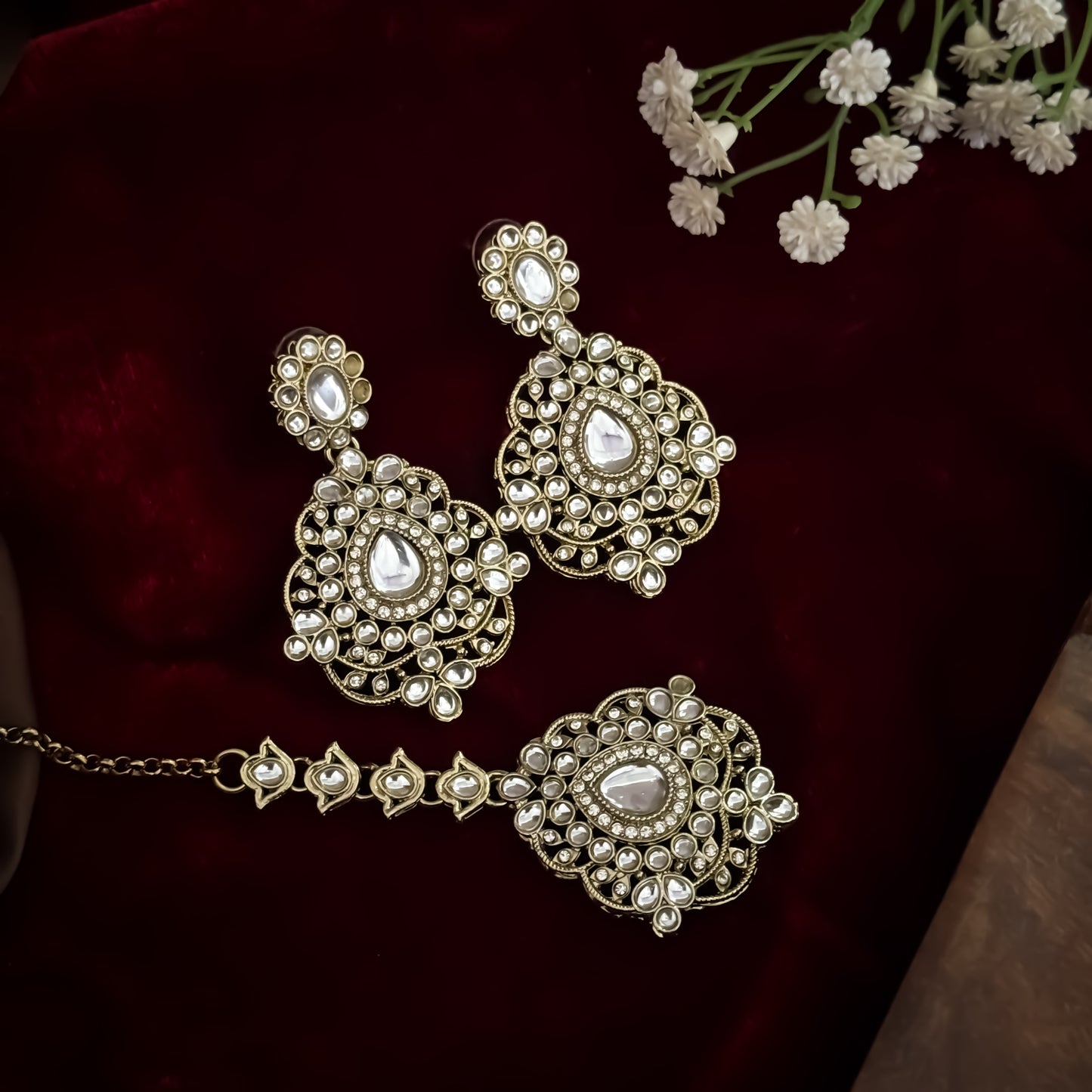 Golden Vanshika premium zircon kundan necklace set featuring oval stone links floral clusters large shield pendant matching earrings and maang tikka