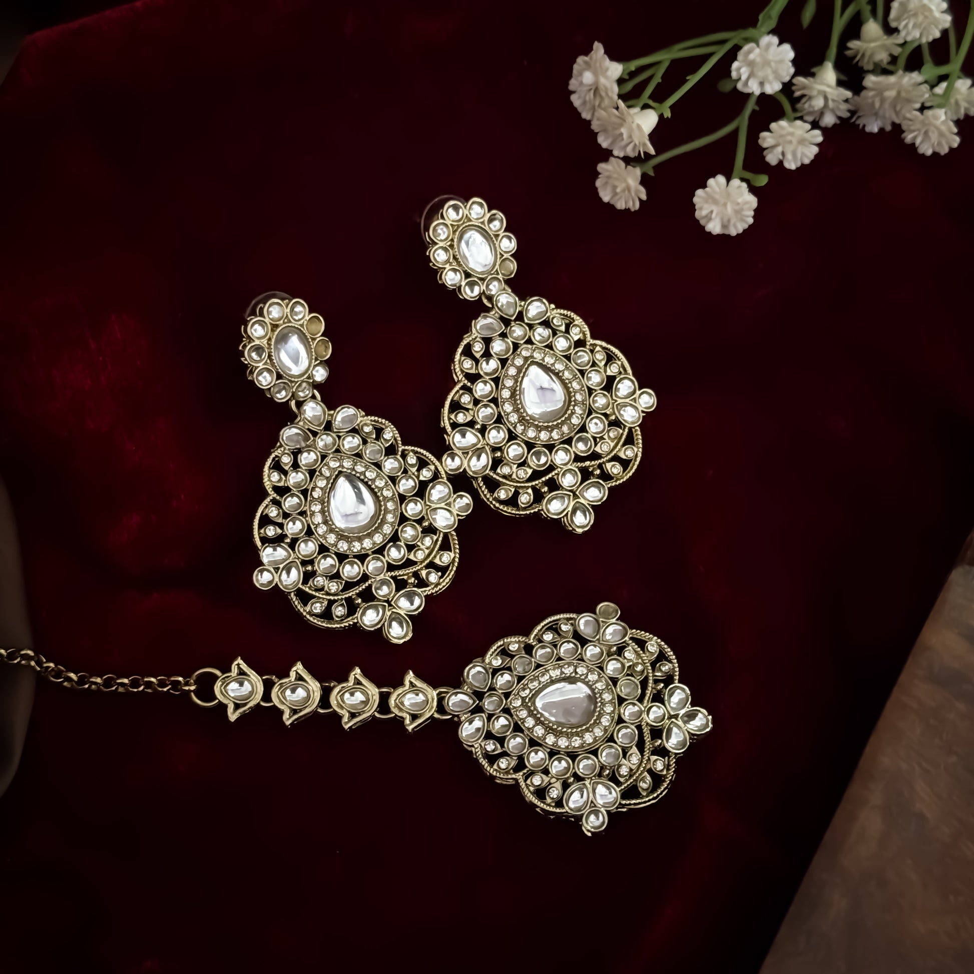 Golden Vanshika premium zircon kundan necklace set featuring oval stone links floral clusters large shield pendant matching earrings and maang tikka