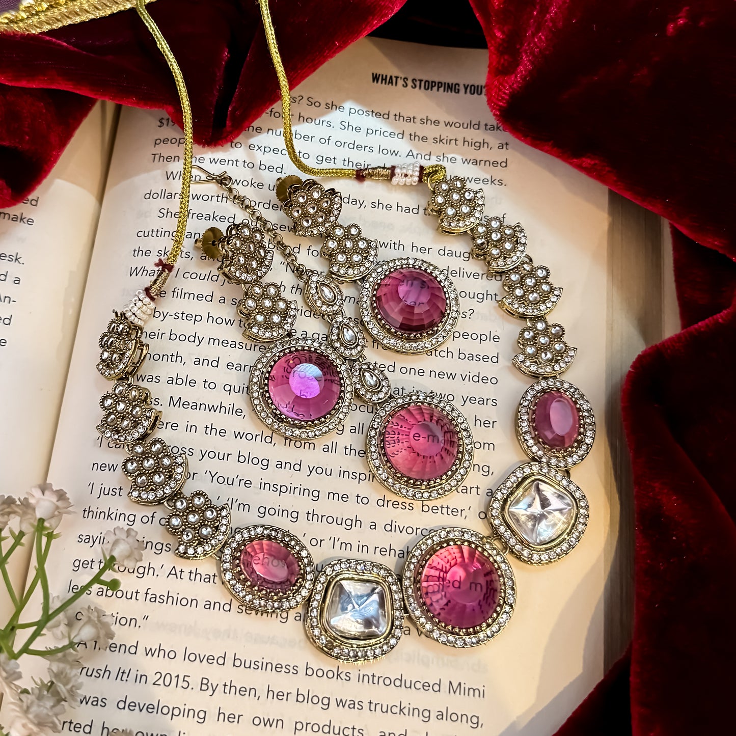 Naira AD premium gold plated necklace set featuring a linear linked tracking of clear mock polki crystal halos a central circular deep wine plum stone medallion matching tiered earrings and a maang tikka