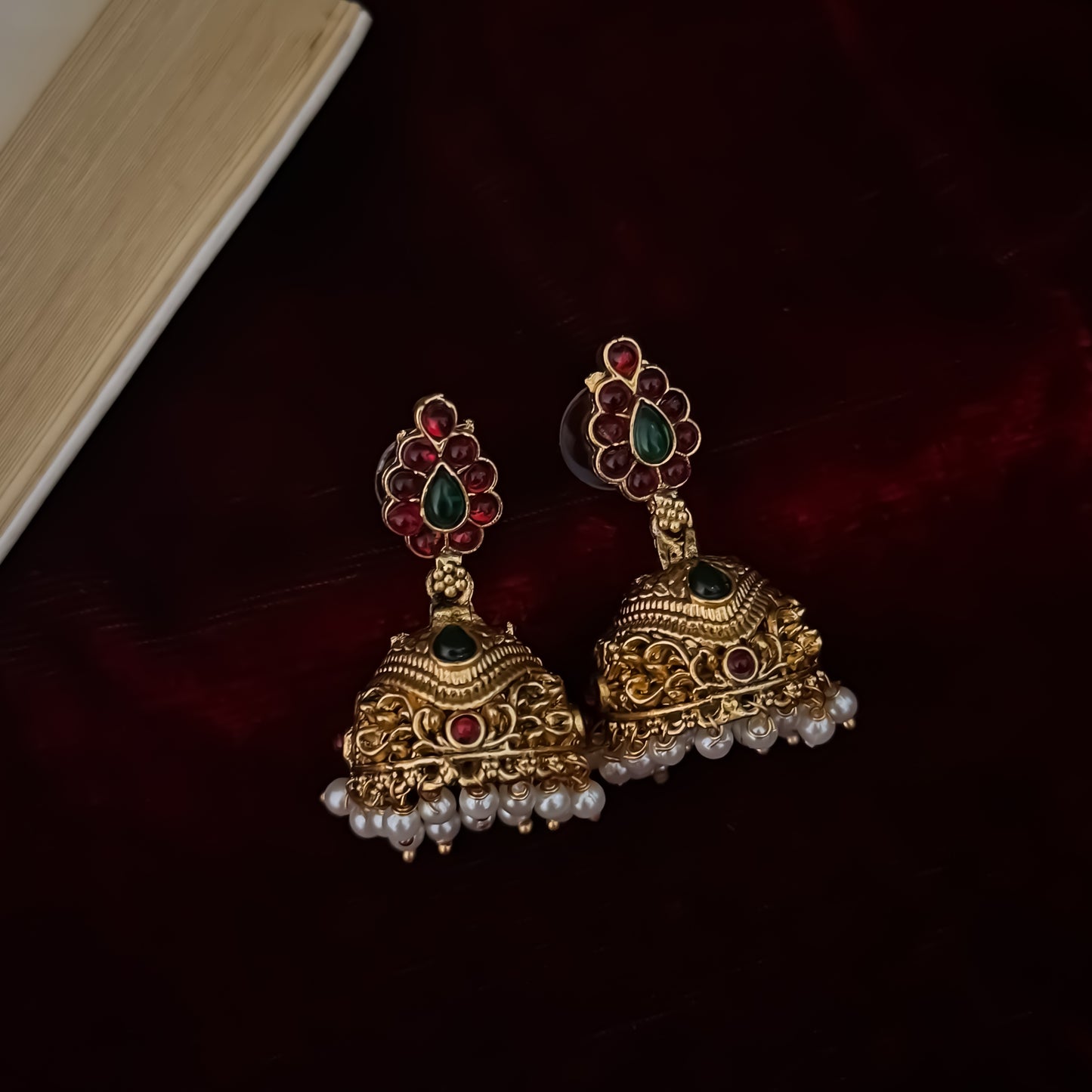 Kalyani premium antique gold temple necklace set featuring continuous rows of floral medallions crescent pendant pink and green stones and pearl drops with matching jhumkas