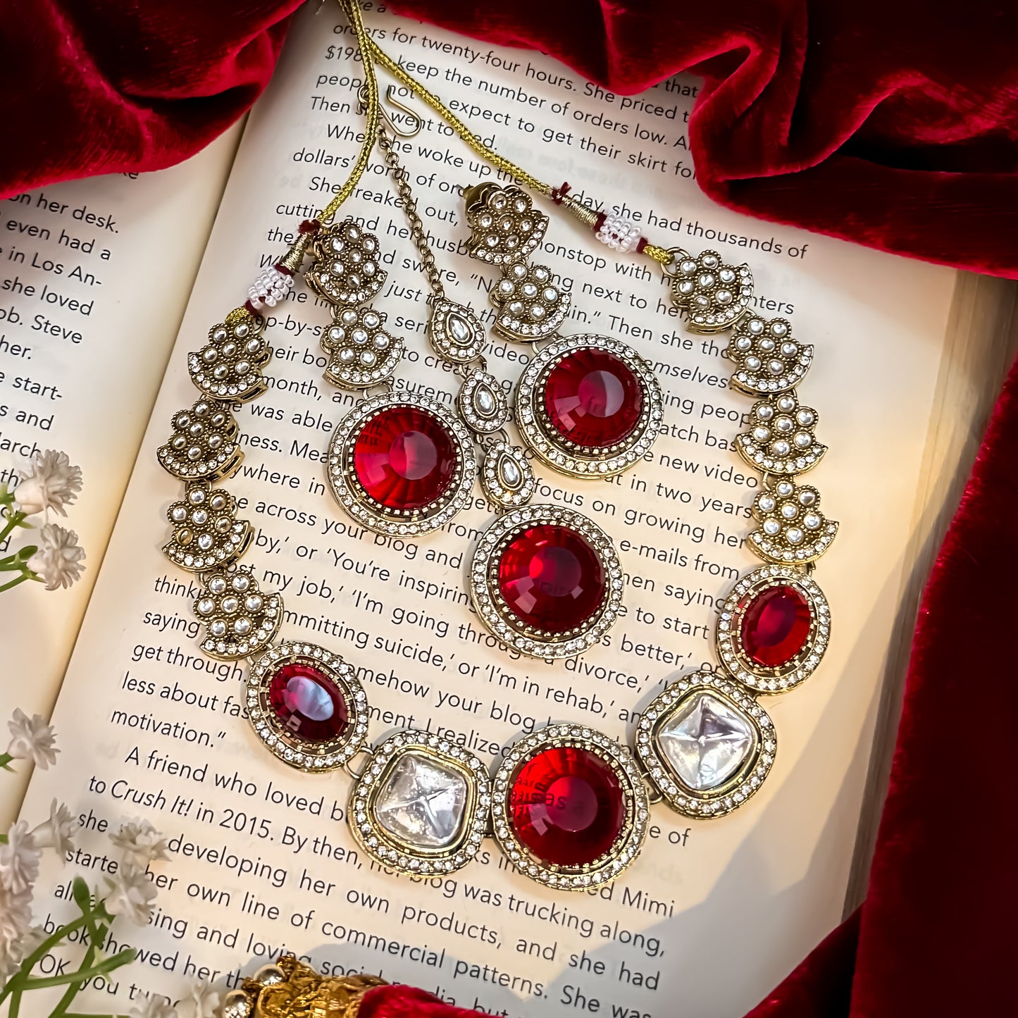 Naira AD premium gold plated necklace set featuring a linear linked tracking of clear mock polki crystal halos a central circular deep wine plum stone medallion matching tiered earrings and a maang tikka