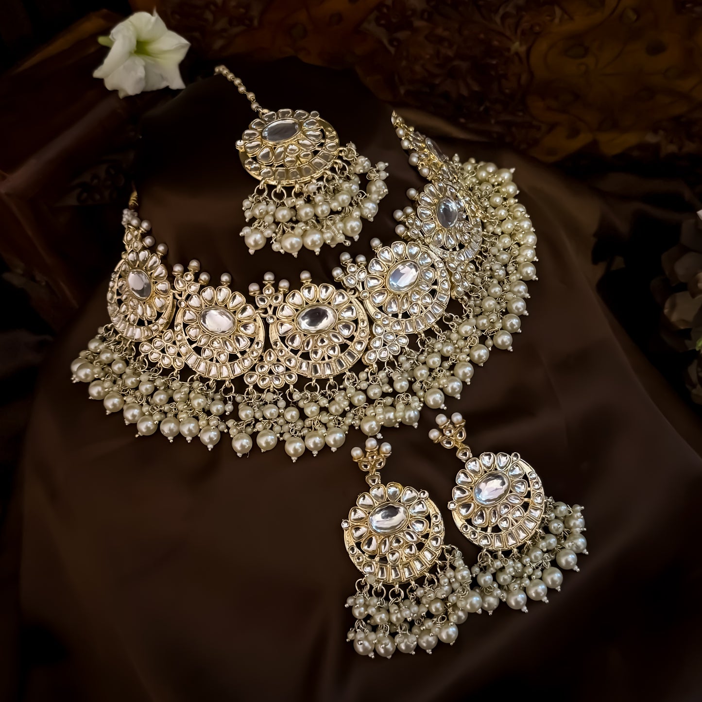 Afreen premium antique gold kundan broad choker necklace set featuring a linear linked tracking of crescent chandbali medallions dense white cluster pearl fringes matching chandelier earrings and maang tikka