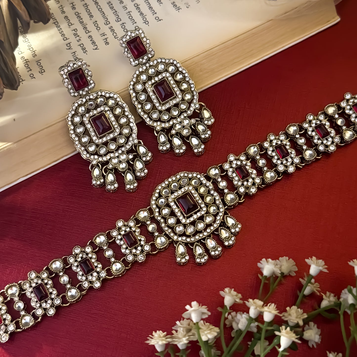 Ruhanika premium antique gold kundan broad choker necklace set featuring a segmented panel collar tracking of rectangular pastel pink quartz stones a large central rounded rectangular medallion matching tiered dropdown earrings