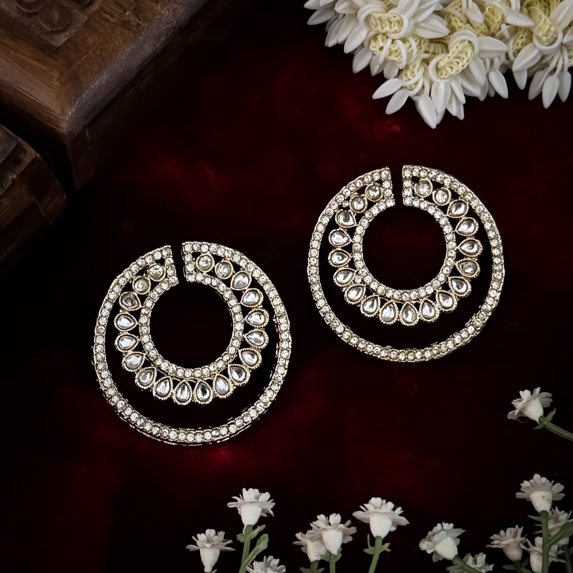 Rabiya premium antique gold kundan statement stud earrings featuring an open crescent circular geometry with concentric halos of teardrop stones and clear pavé crystals