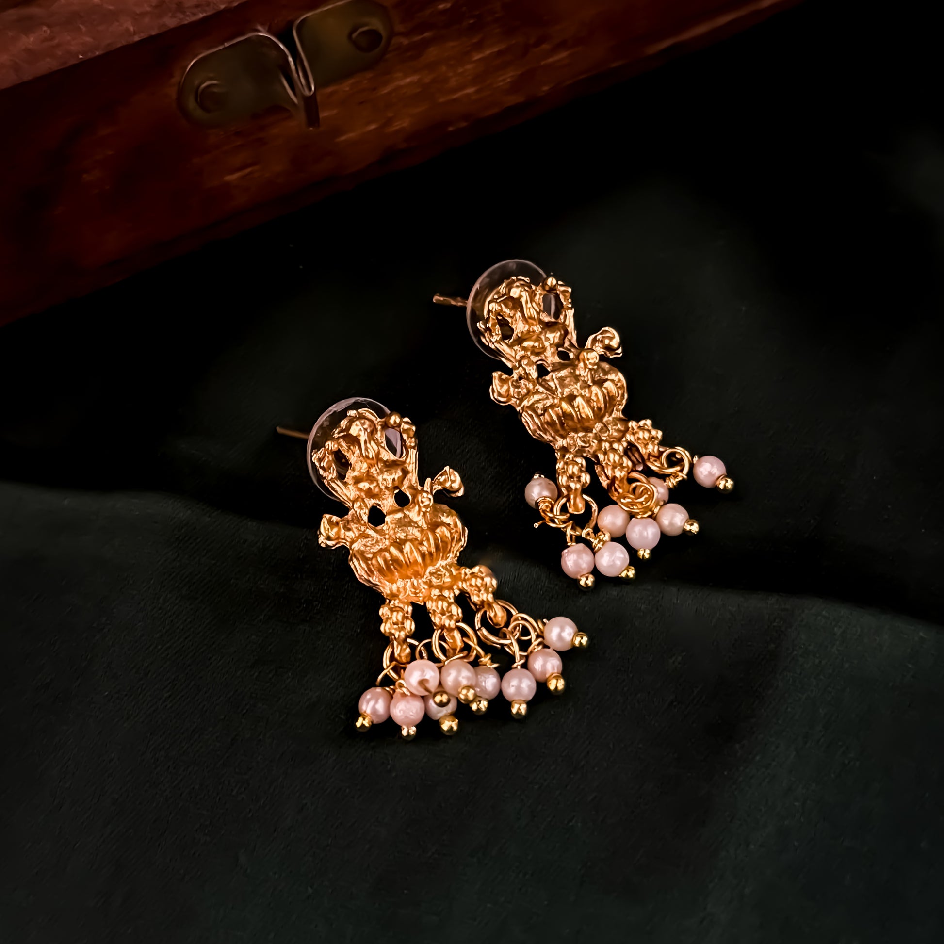 Bhavika temple jewelry hasli necklace set featuring a matte gold goddess lakshmi pendant with ruby stones and hanging green crystal drops