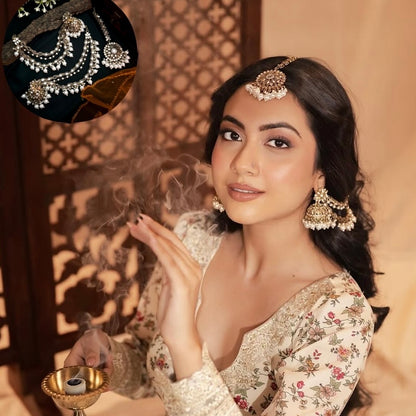 Traditional antique gold kundan mirror work bridal jewelry set styled on a woman with loose dark hair wearing a cream floral embroidered lehenga blouse