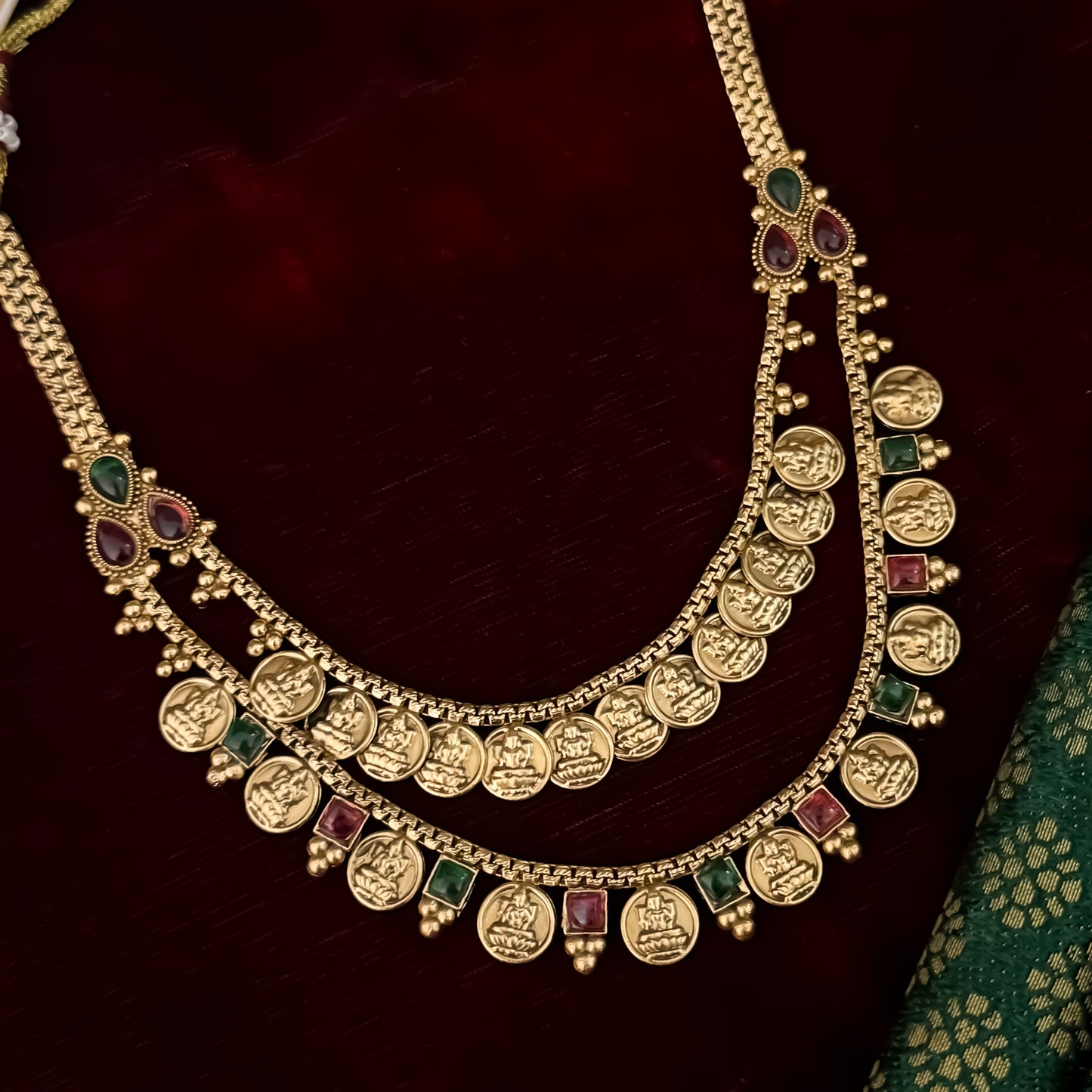 Padma premium antique gold temple kasu mala necklace set featuring double rows of sculpted goddess lakshmi coins pink and green stones with matching earrings