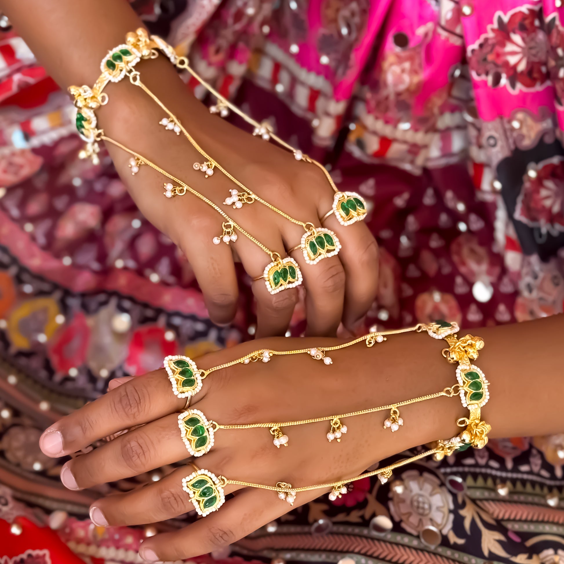 Kamaltika adjustable brass three finger haathphool pair featuring emerald green enameled lotus charms with small hanging seed pearls