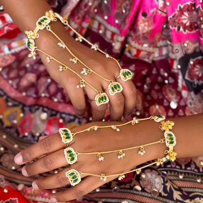 Kamaltika adjustable brass three finger haathphool pair featuring emerald green enameled lotus charms with small hanging seed pearls