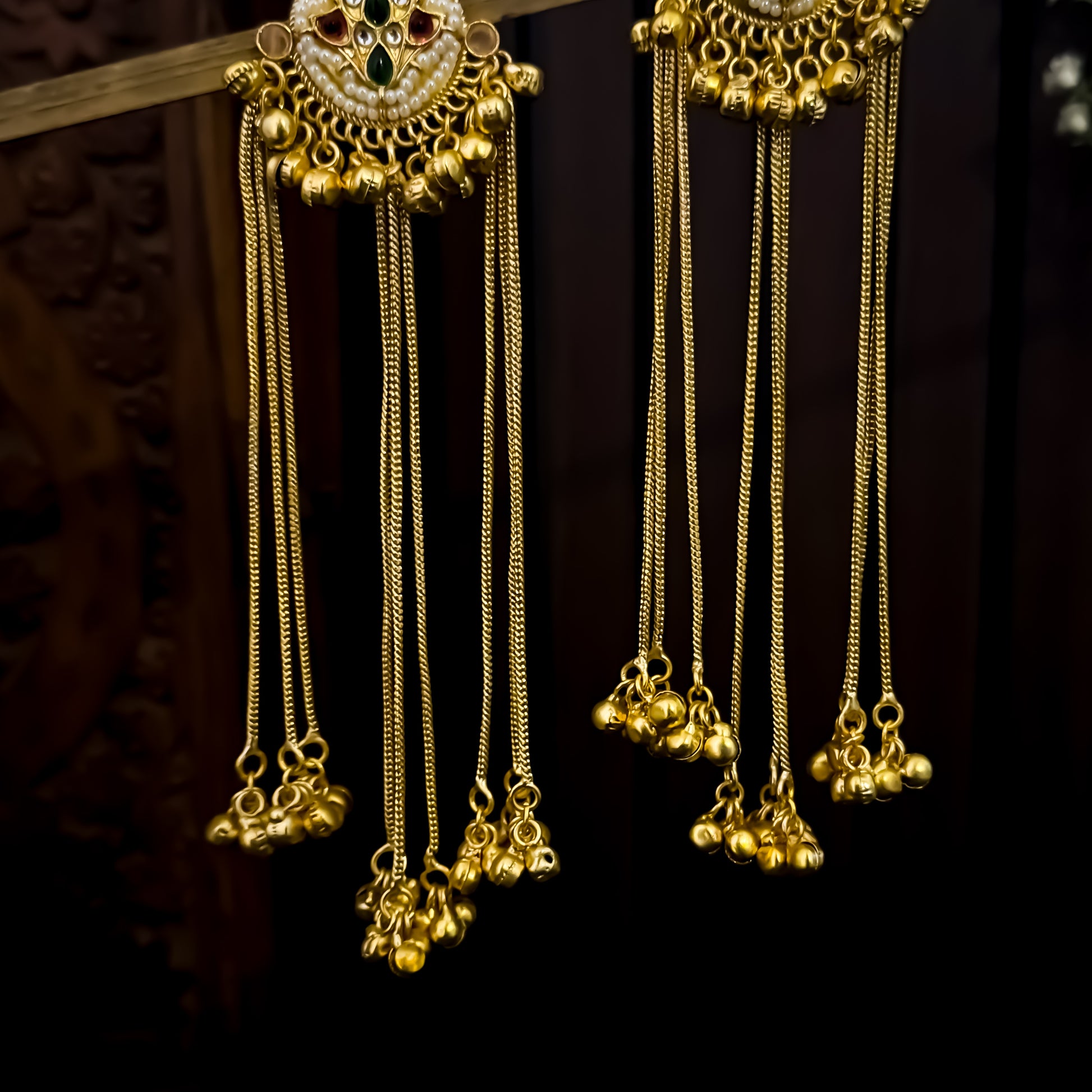 Nida premium kashmiri brass earrings featuring circular kundan studs with pink and green stones and long cascading gold ghungroo chains