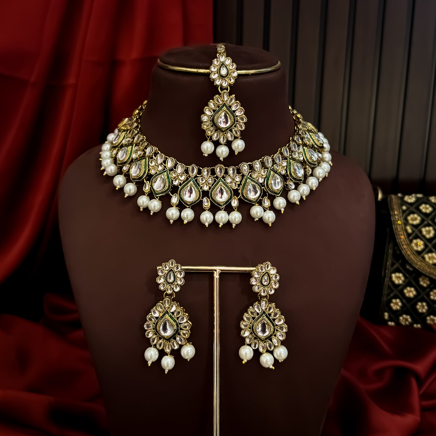 Kumud premium antique gold kundan choker necklace set featuring emerald green enamel borders and hanging white pearl drops with matching earrings and maang teeka