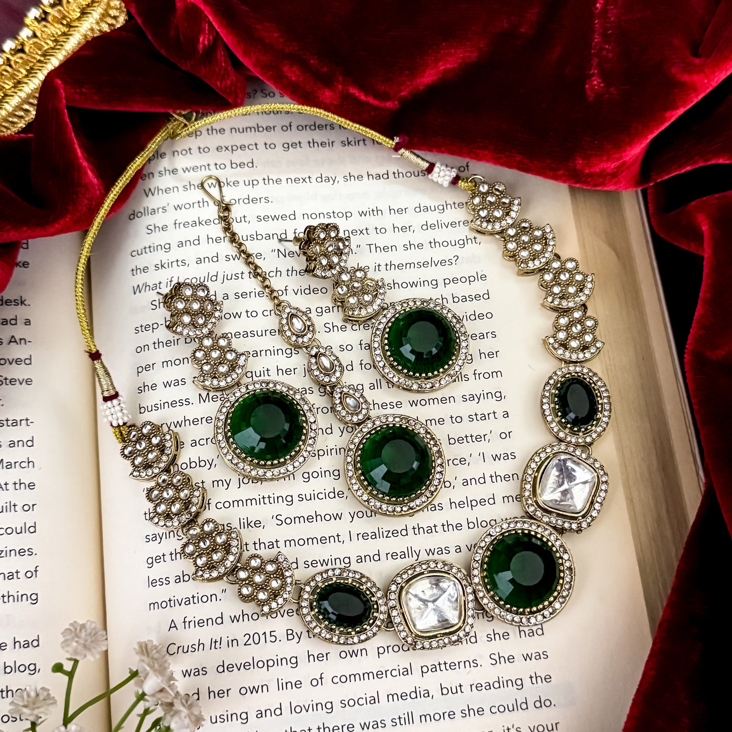 Naira AD premium gold plated necklace set featuring a linear linked tracking of clear mock polki crystal halos a central circular deep wine plum stone medallion matching tiered earrings and a maang tikka