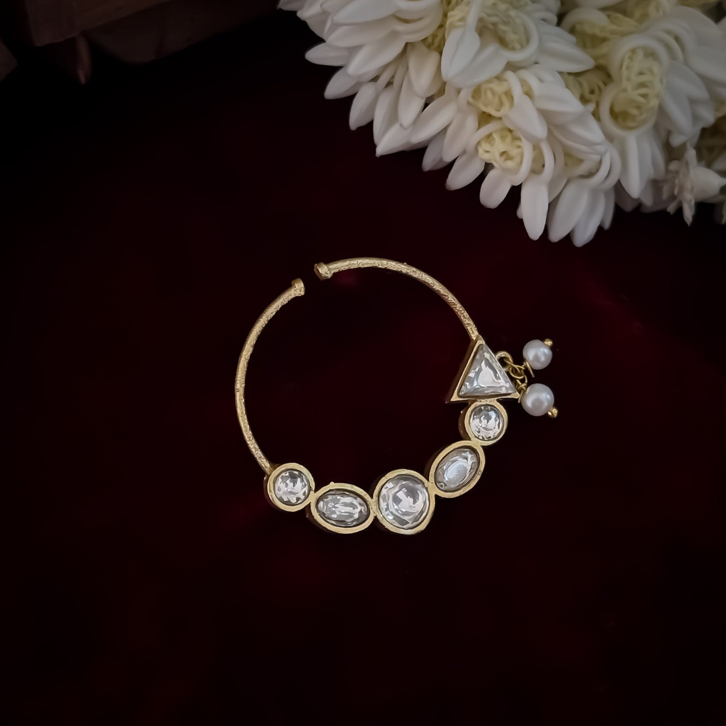 Shreya premium antique gold kundan nose clip nath featuring a non pierced hoop encrusted with a crescent arch of multi shape clear dabi stones a triangular tip and two swinging white pearls