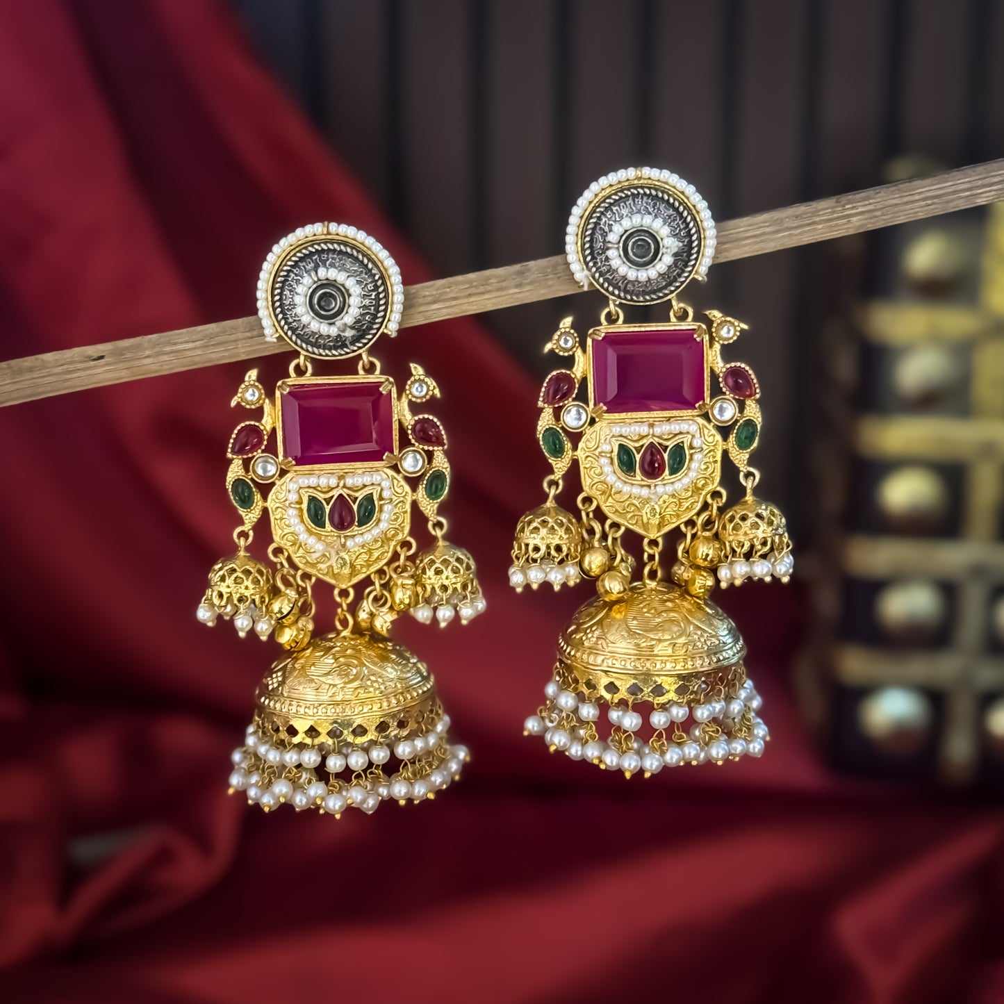 Roshni premium antique gold kashmiri earrings featuring dual tone oxidized silver chakra studs a large rectangular magenta quartz gemstone shield a kemp stone peacock link and multiple jhumka domes with dense micro pearl fringes