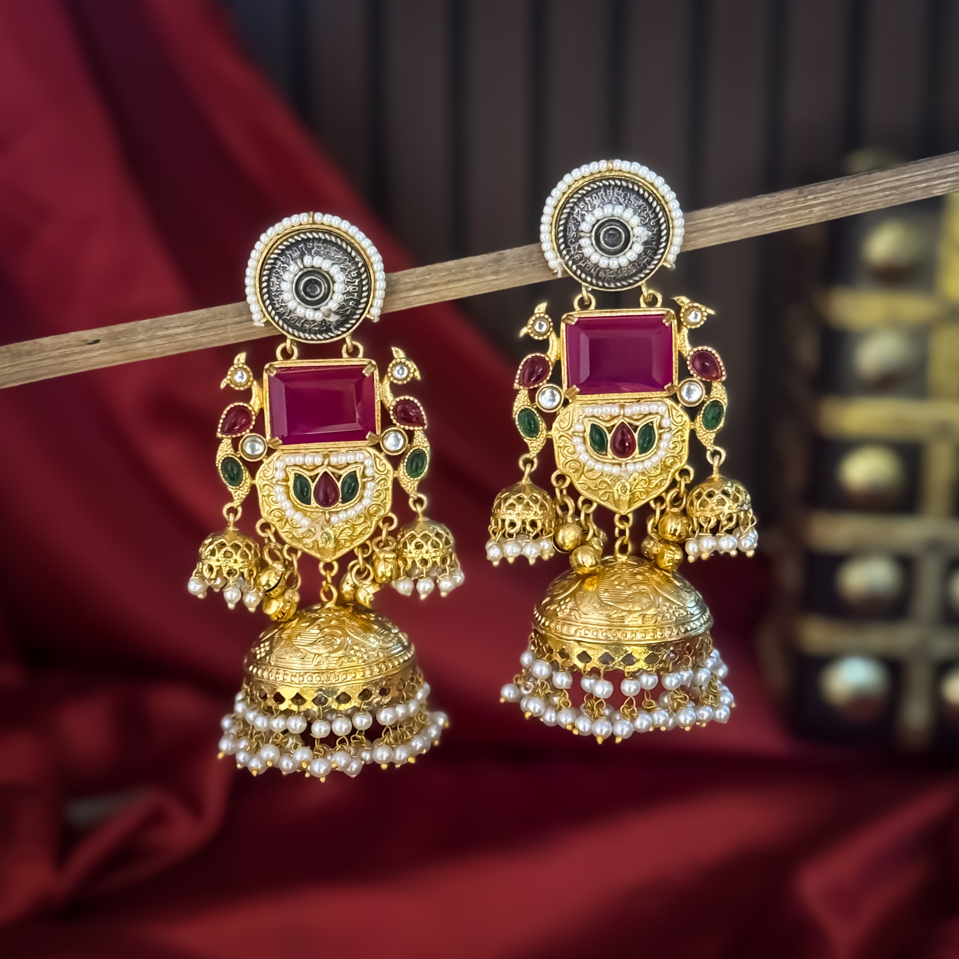 Roshni premium antique gold kashmiri earrings featuring dual tone oxidized silver chakra studs a large rectangular magenta quartz gemstone shield a kemp stone peacock link and multiple jhumka domes with dense micro pearl fringes