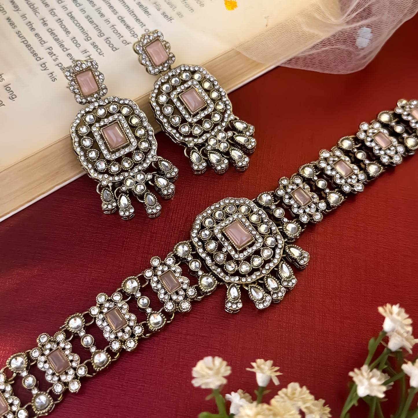 Ruhanika premium antique gold kundan broad choker necklace set featuring a segmented panel collar tracking of rectangular pastel pink quartz stones a large central rounded rectangular medallion matching tiered dropdown earrings